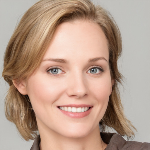 Joyful white young-adult female with medium  brown hair and blue eyes