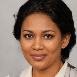 Joyful black adult female with medium  brown hair and brown eyes