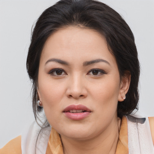 Joyful asian young-adult female with medium  brown hair and brown eyes