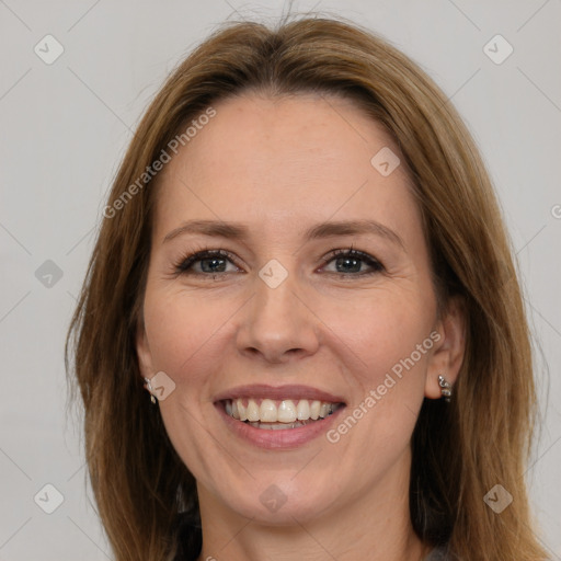 Joyful white adult female with long  brown hair and brown eyes