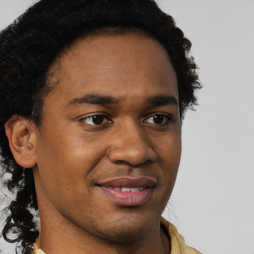 Joyful black young-adult male with short  brown hair and brown eyes