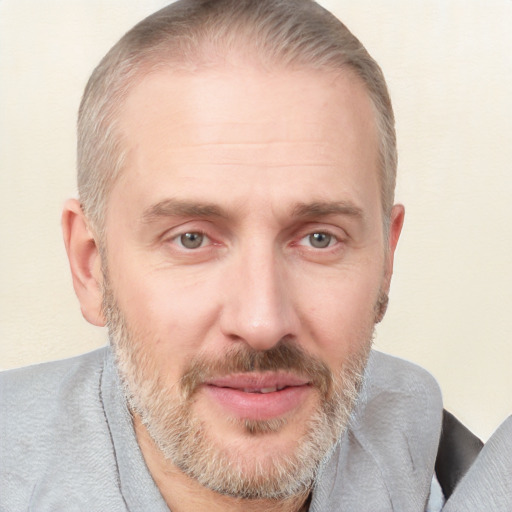 Joyful white adult male with short  brown hair and grey eyes