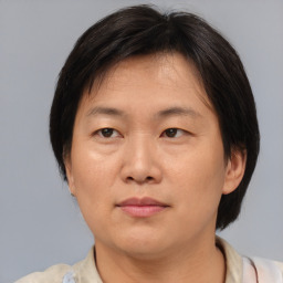 Joyful asian adult female with medium  brown hair and brown eyes