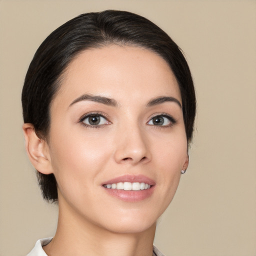 Joyful white young-adult female with medium  black hair and brown eyes