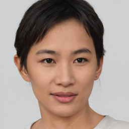Joyful asian young-adult female with short  brown hair and brown eyes