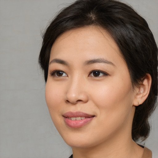 Joyful asian young-adult female with medium  brown hair and brown eyes