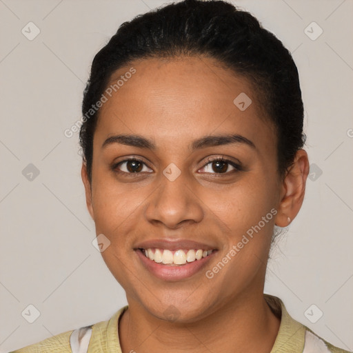 Joyful latino young-adult female with short  black hair and brown eyes