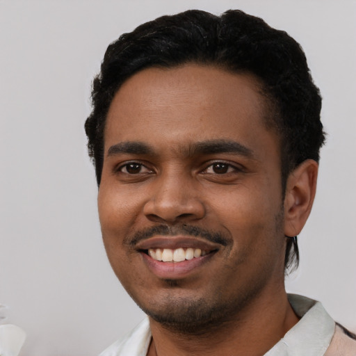 Joyful black young-adult male with short  black hair and brown eyes