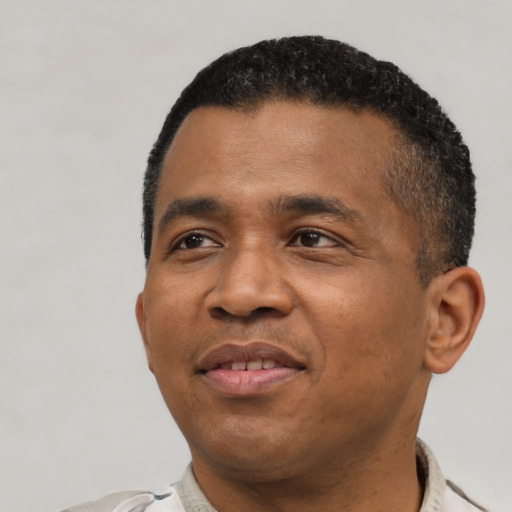 Joyful latino adult male with short  black hair and brown eyes
