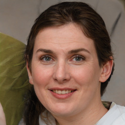 Joyful white adult female with medium  brown hair and brown eyes