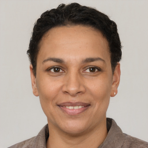 Joyful latino adult female with short  brown hair and brown eyes