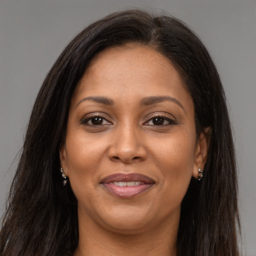 Joyful latino adult female with long  brown hair and brown eyes