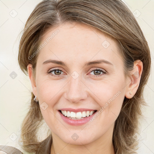 Joyful white young-adult female with medium  brown hair and green eyes