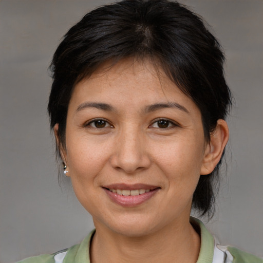 Joyful asian adult female with medium  brown hair and brown eyes