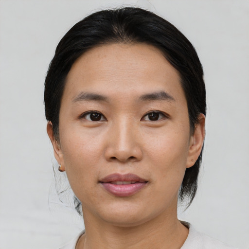 Joyful asian young-adult female with short  black hair and brown eyes
