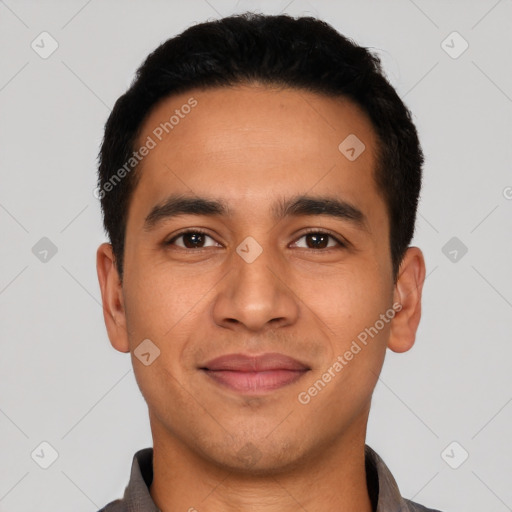 Joyful latino young-adult male with short  black hair and brown eyes