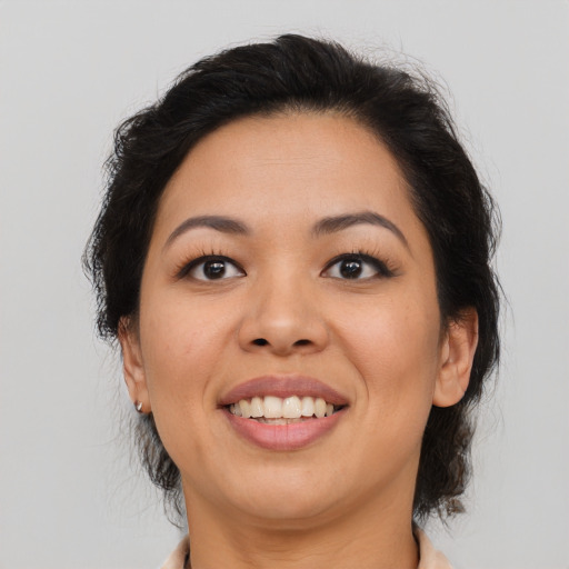 Joyful asian adult female with medium  brown hair and brown eyes