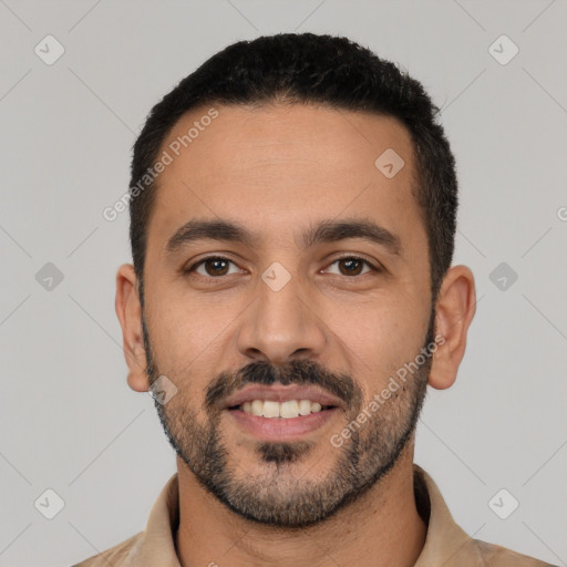 Joyful white young-adult male with short  black hair and brown eyes