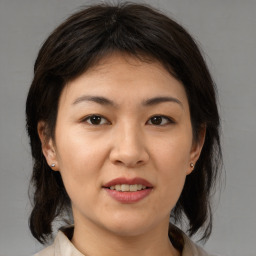 Joyful asian young-adult female with medium  brown hair and brown eyes