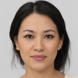 Joyful asian young-adult female with medium  brown hair and brown eyes