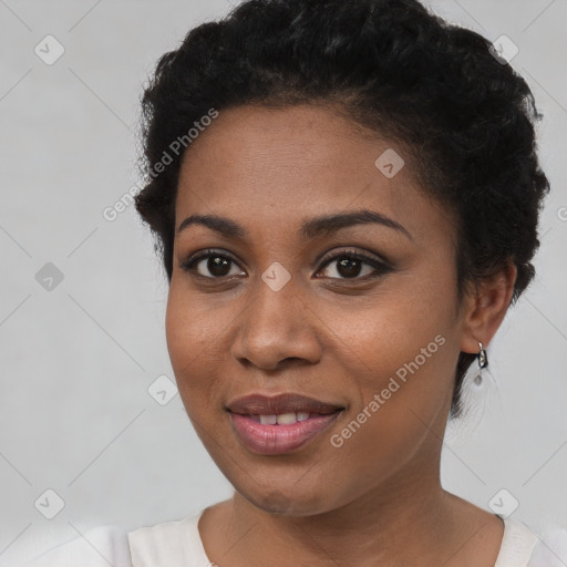 Joyful black young-adult female with short  brown hair and brown eyes