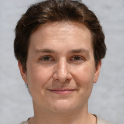 Joyful white adult female with short  brown hair and brown eyes