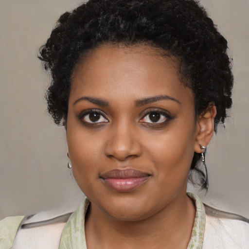 Joyful black young-adult female with medium  black hair and brown eyes