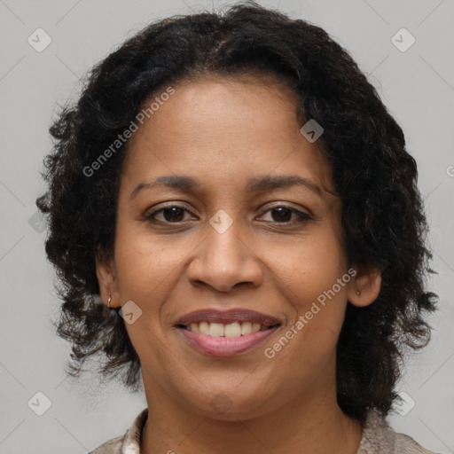 Joyful black adult female with medium  brown hair and brown eyes