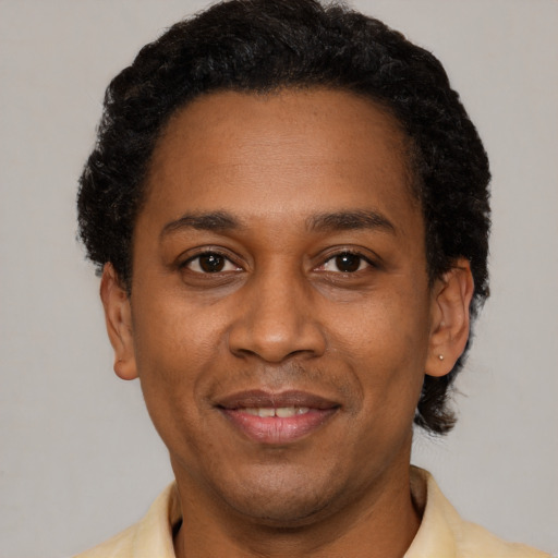 Joyful latino adult male with short  black hair and brown eyes