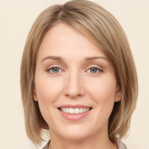 Joyful white young-adult female with medium  brown hair and green eyes