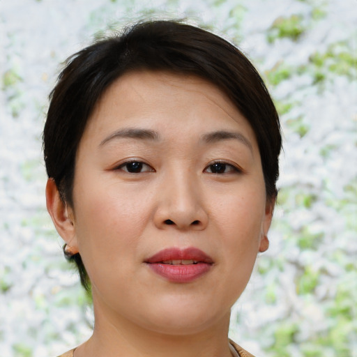 Joyful asian young-adult female with short  brown hair and brown eyes