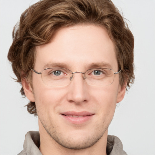 Joyful white adult male with short  brown hair and blue eyes