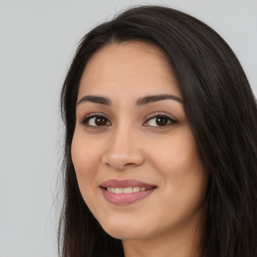 Joyful white young-adult female with long  black hair and brown eyes