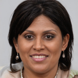 Joyful white adult female with medium  brown hair and brown eyes