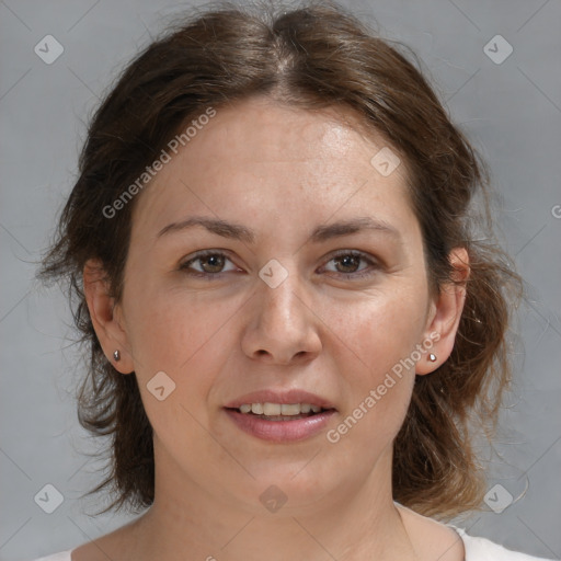 Joyful white adult female with medium  brown hair and brown eyes