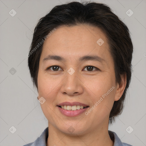 Joyful asian adult female with medium  brown hair and brown eyes