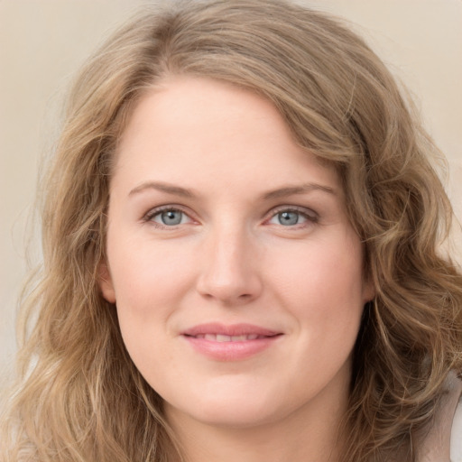 Joyful white young-adult female with long  brown hair and green eyes