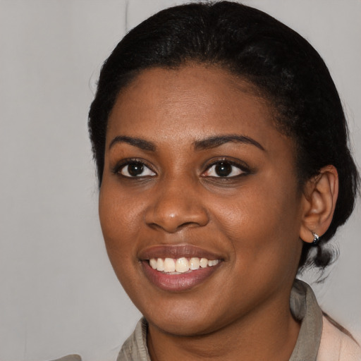Joyful black young-adult female with medium  black hair and brown eyes
