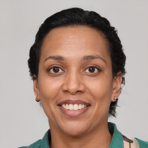 Joyful latino adult female with short  black hair and brown eyes