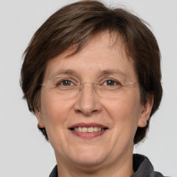 Joyful white middle-aged female with medium  brown hair and brown eyes