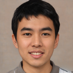 Joyful asian young-adult male with short  black hair and brown eyes