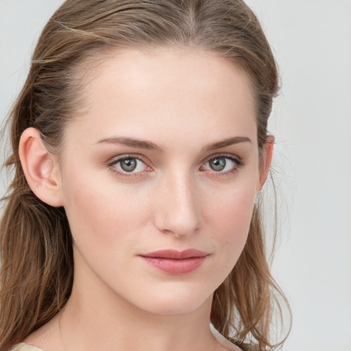 Joyful white young-adult female with long  brown hair and blue eyes