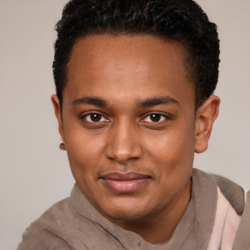 Joyful black young-adult male with short  brown hair and brown eyes