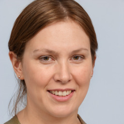 Joyful white adult female with medium  brown hair and grey eyes