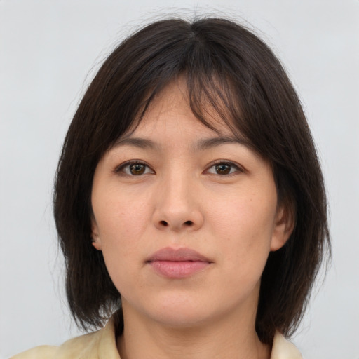 Neutral asian young-adult female with medium  brown hair and brown eyes