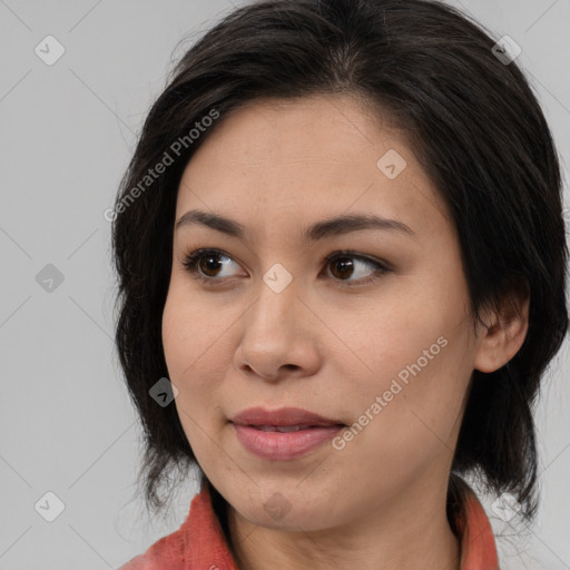 Joyful latino young-adult female with medium  brown hair and brown eyes