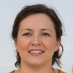 Joyful white adult female with medium  brown hair and brown eyes