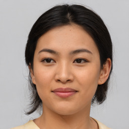 Joyful asian young-adult female with medium  brown hair and brown eyes