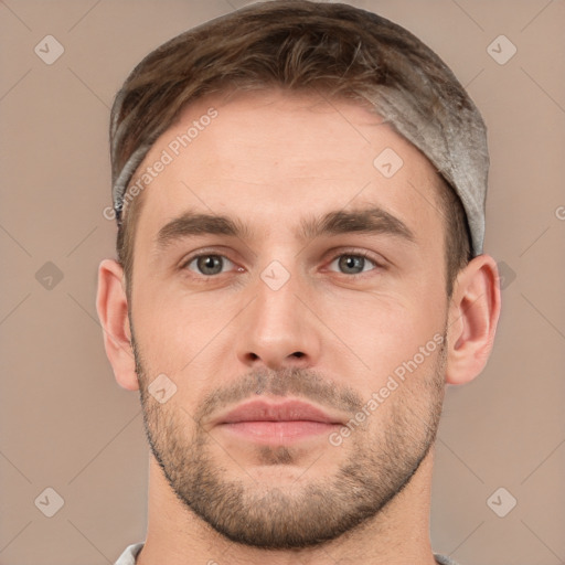 Joyful white young-adult male with short  brown hair and grey eyes