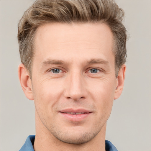 Joyful white adult male with short  brown hair and grey eyes